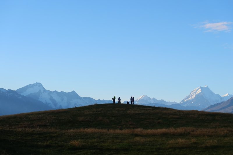 A group on a tussock ridge on the Alps 2 Ocean, the Southern Alps behind
