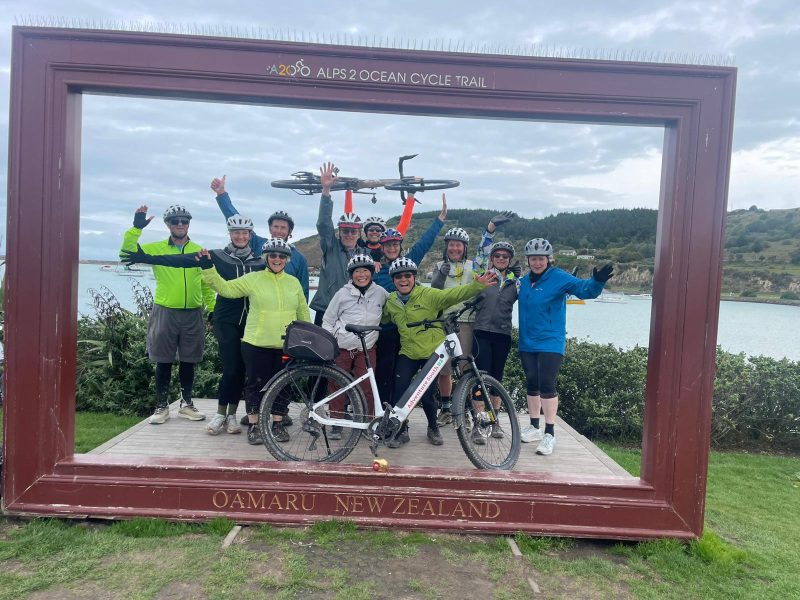 An Adventure South group at the Alps 2 Ocean finish frame in Oamaru