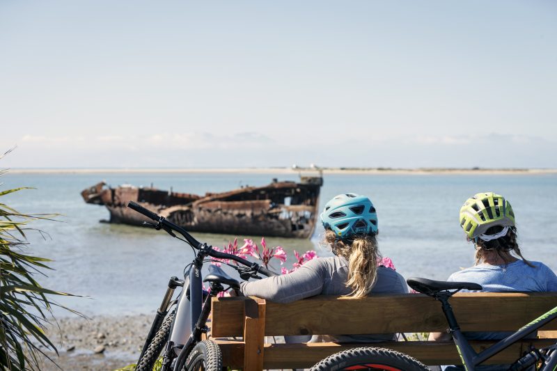 Riders resting by the Janie Seddon shipwreck at Motueka