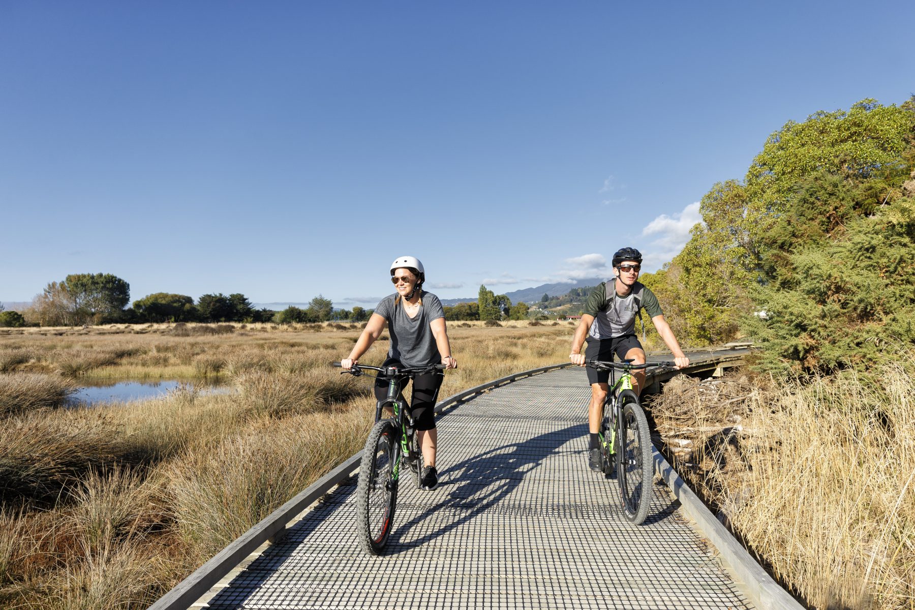 Two riders on the boardwalk section of the Great Taste Trail