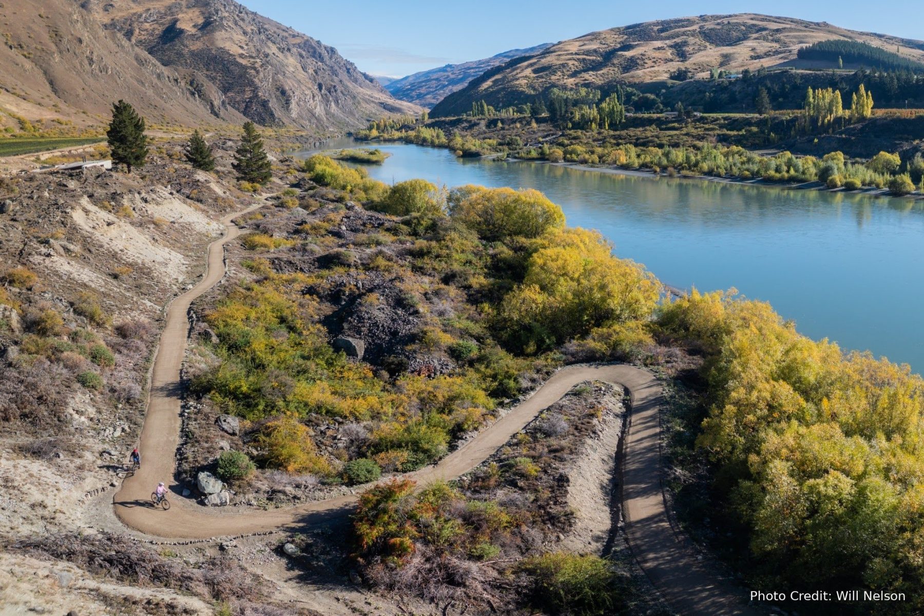 A rider on the Kawarau Gorge Trail above the river in autumn