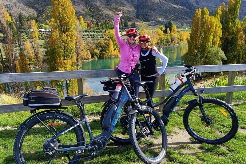 Two riders celebrating at the end of the Lake Dunstan Trail