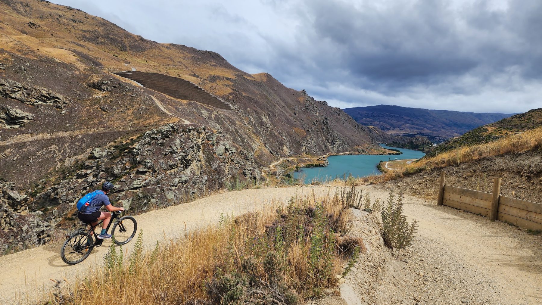 A rider on the Cairnmuir switchbacks above Lake Dunstan