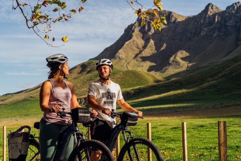 Two riders with e-bikes below Te Mata Peak