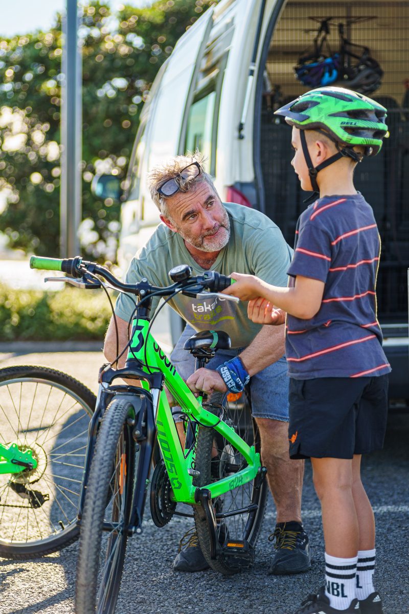 A young rider being set up with a bike at the Takaro Trails van